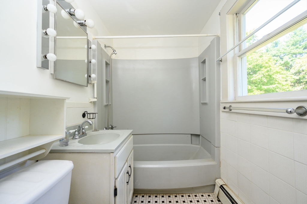 8 Walnut Street Whitman, MA 02382 - Photo 5 of 17 a bathroom with a tub a sink and a window