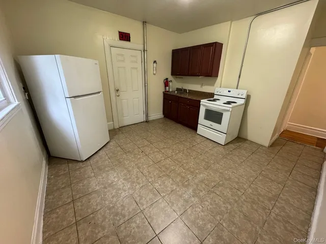 a kitchen with stainless steel appliances a refrigerator stove and microwave