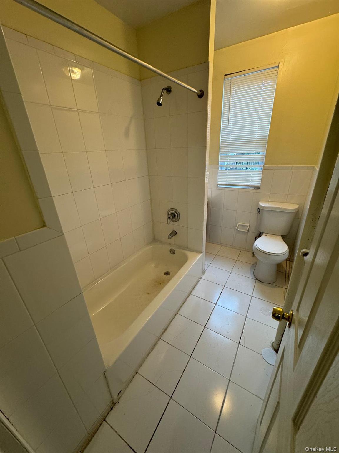 22 Clove Road, Unit 24C New Rochelle, NY 10801 - Photo 6 of 9 a bathroom with a granite countertop bathtub shower and toilet