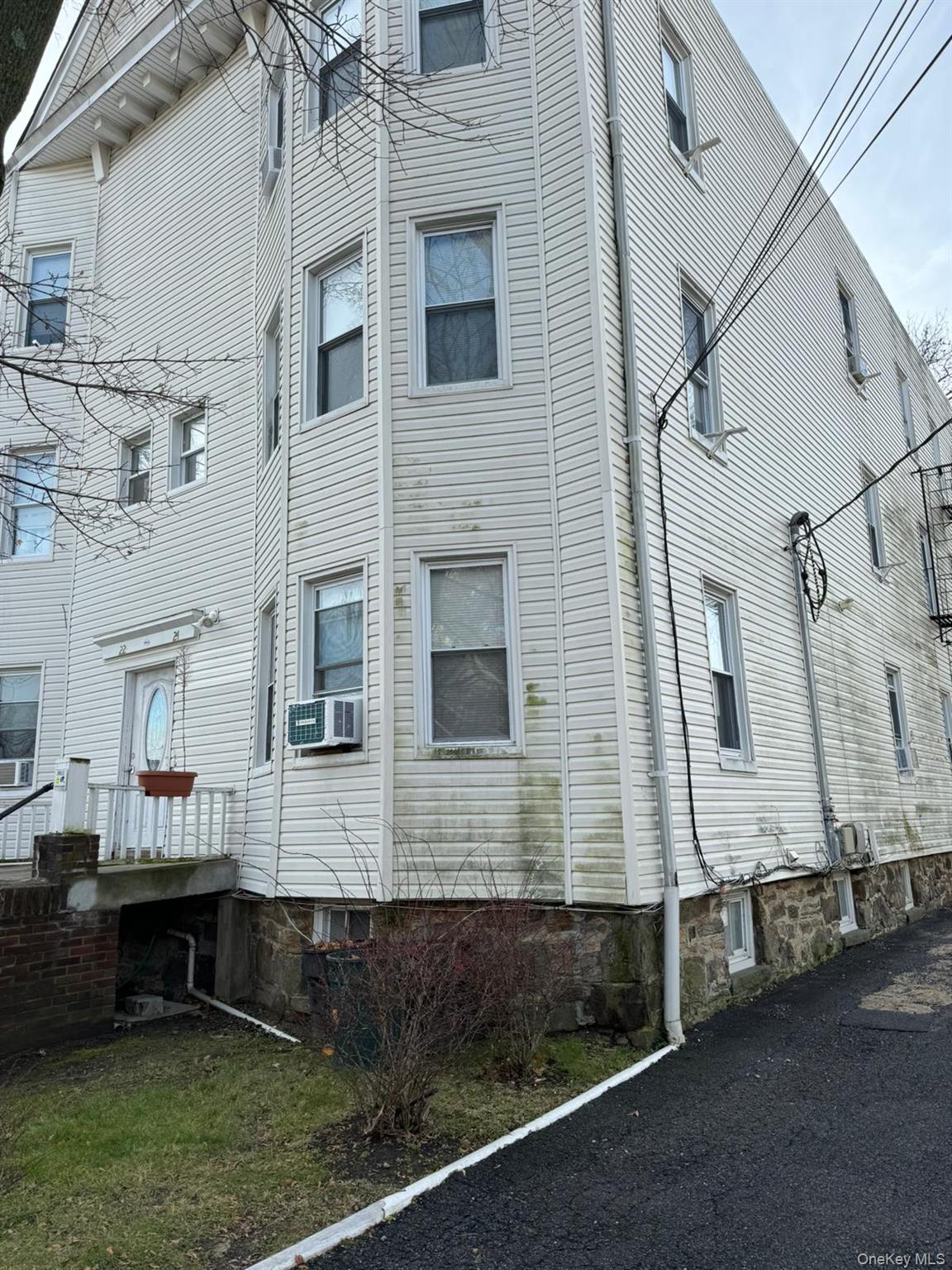 22 Clove Road, Unit 24C New Rochelle, NY 10801 - Photo 7 of 9 a front view of a house with a yard