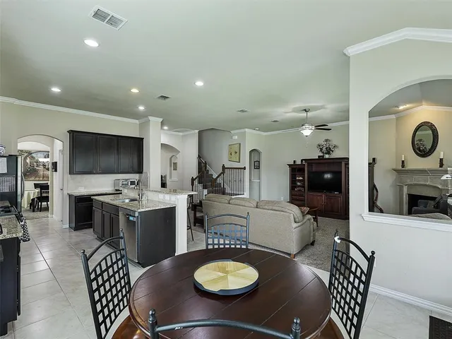 a living room with furniture a flat screen tv and a view of kitchen