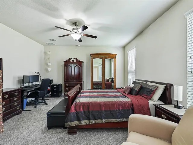 a bedroom with bed and window