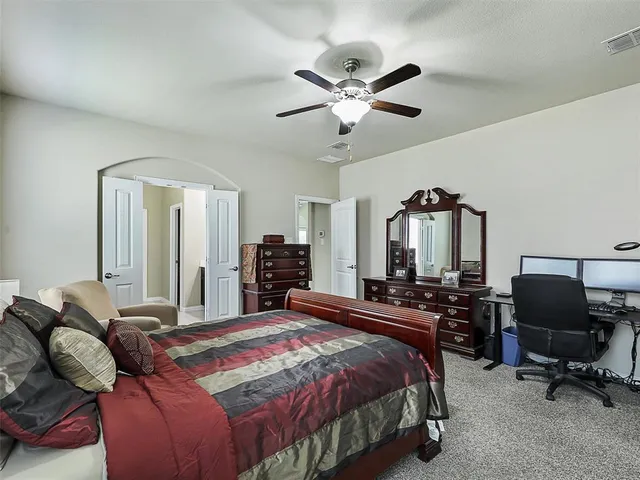 a bedroom with a bed and a chair