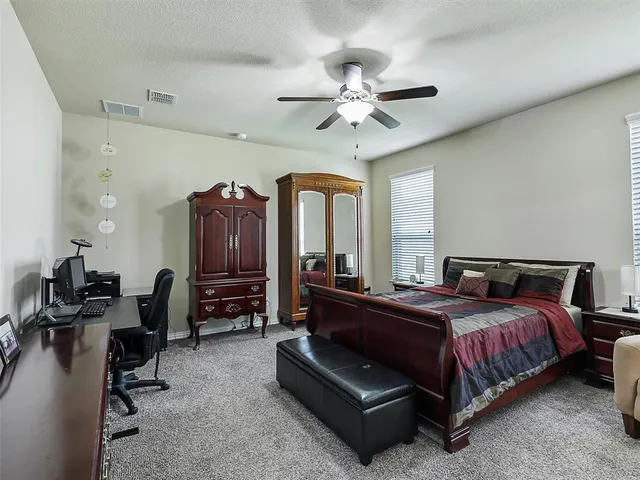 a bedroom with a bed gym equipment and a chandelier