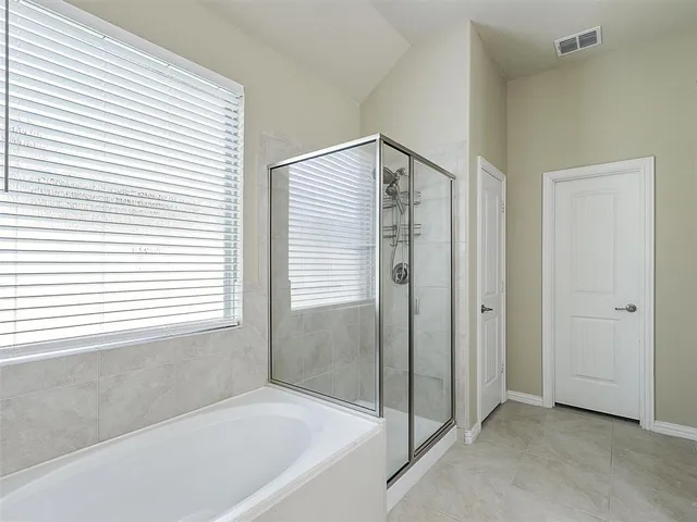 a bathroom with a bathtub and a shower