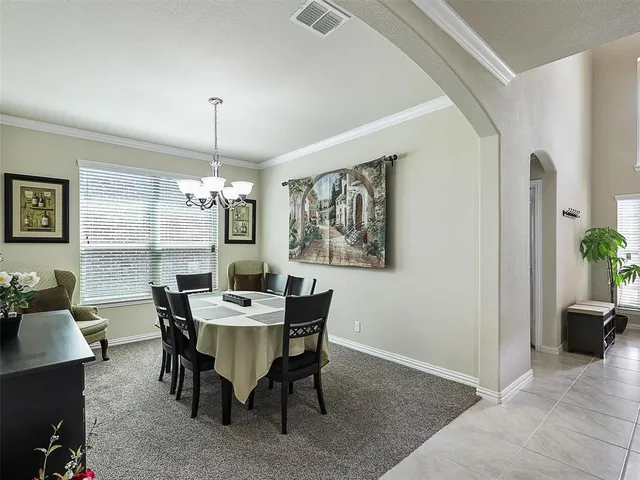 a view of a dining room with furniture and window