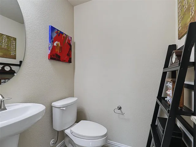 a white toilet sitting next to a bathroom sink
