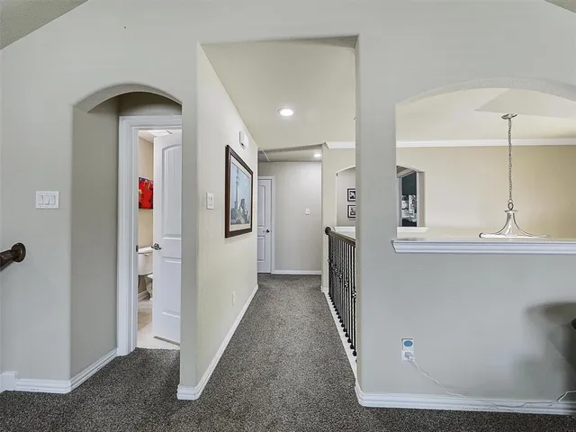 a view of hallway with stairs and wooden floor