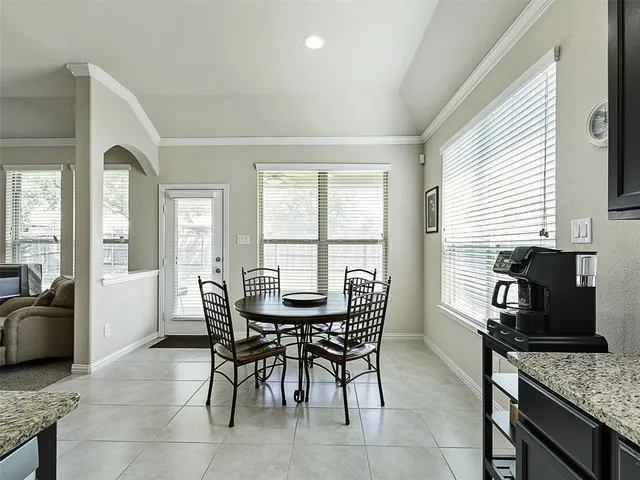 a view of a dining room with furniture and a window