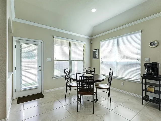 a view of a dining room with furniture and a window