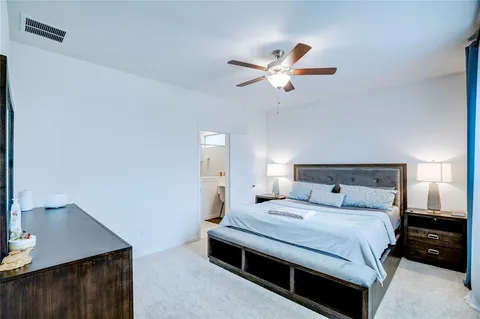 a bedroom with a bed and a night stand