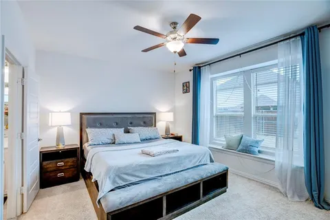 a bedroom with a large bed and a large window