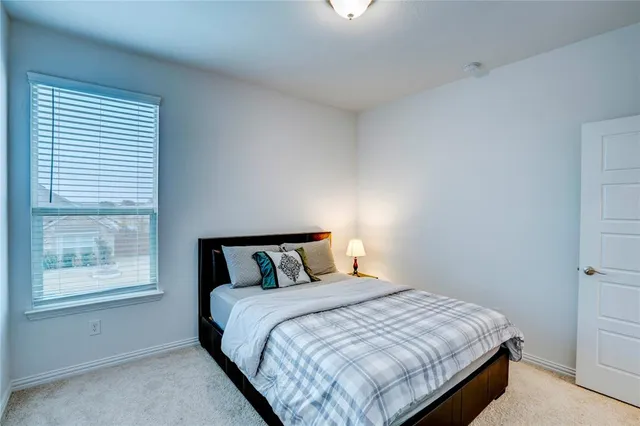 a bedroom with a bed and window