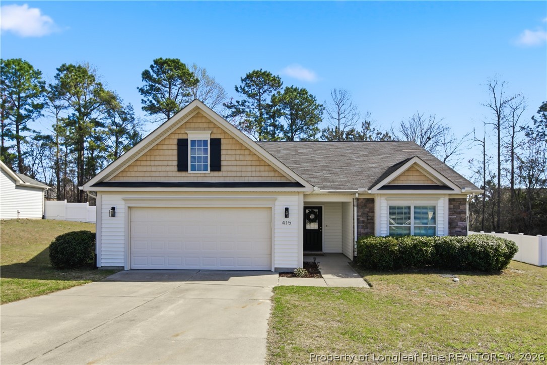 415 Colonist Place Cameron, NC 28326 - Photo 1 of 49 a front view of a house with a yard and garage