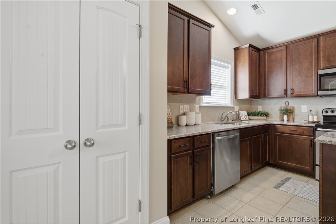 415 Colonist Place Cameron, NC 28326 - Photo 14 of 49 a kitchen with stainless steel appliances granite countertop a sink and cabinets