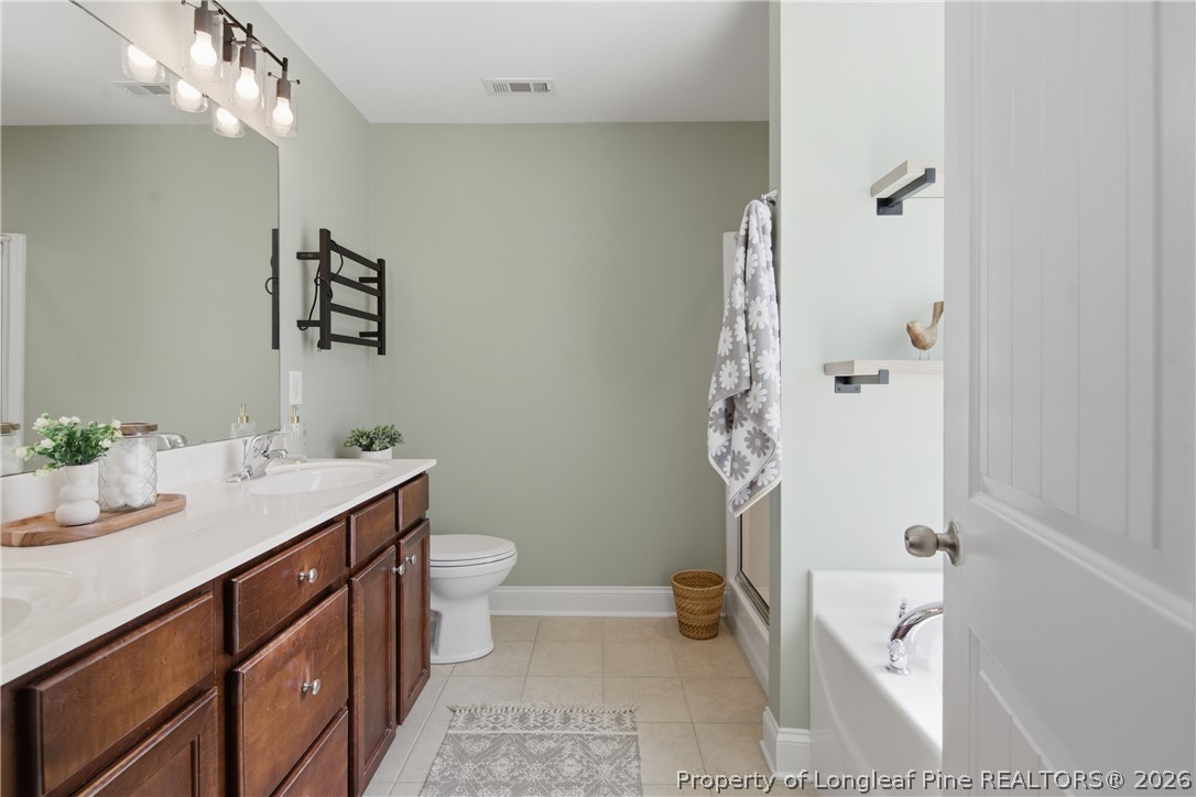 415 Colonist Place Cameron, NC 28326 - Photo 23 of 49 a bathroom with a sink a toilet and shower