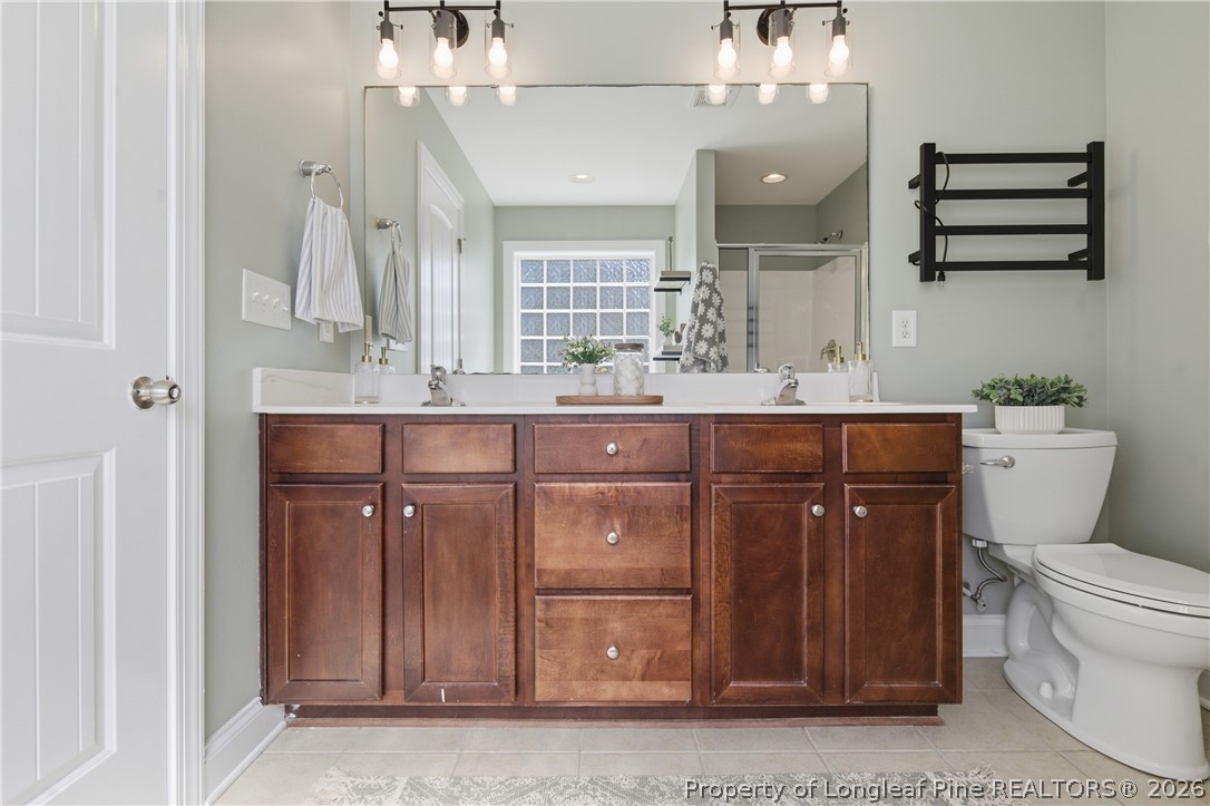 415 Colonist Place Cameron, NC 28326 - Photo 24 of 49 a bathroom with a sink a toilet and mirror