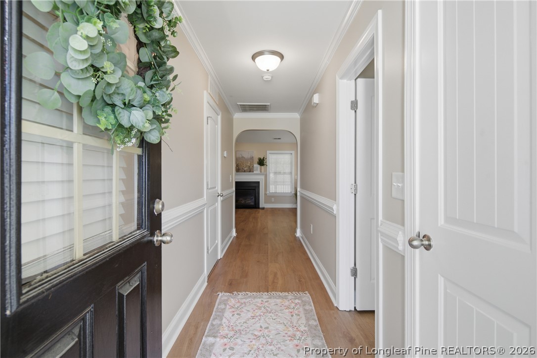 415 Colonist Place Cameron, NC 28326 - Photo 3 of 49 a view of a hallway with wooden floor and staircase