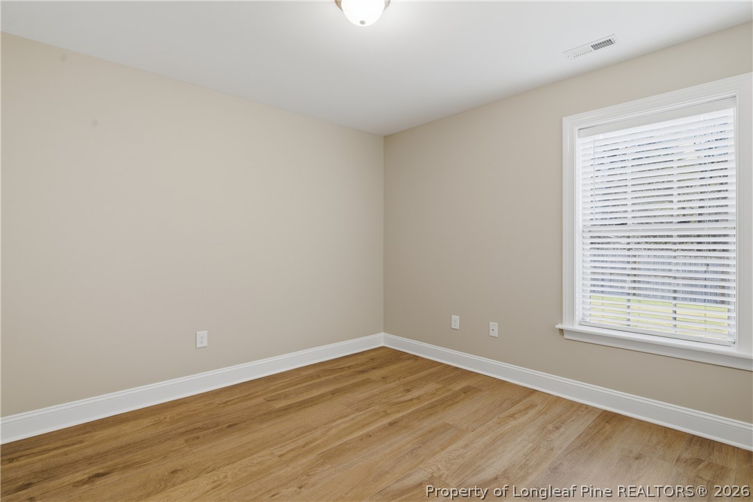 415 Colonist Place Cameron, NC 28326 - Photo 35 of 49 wooden floor in an empty room with a window