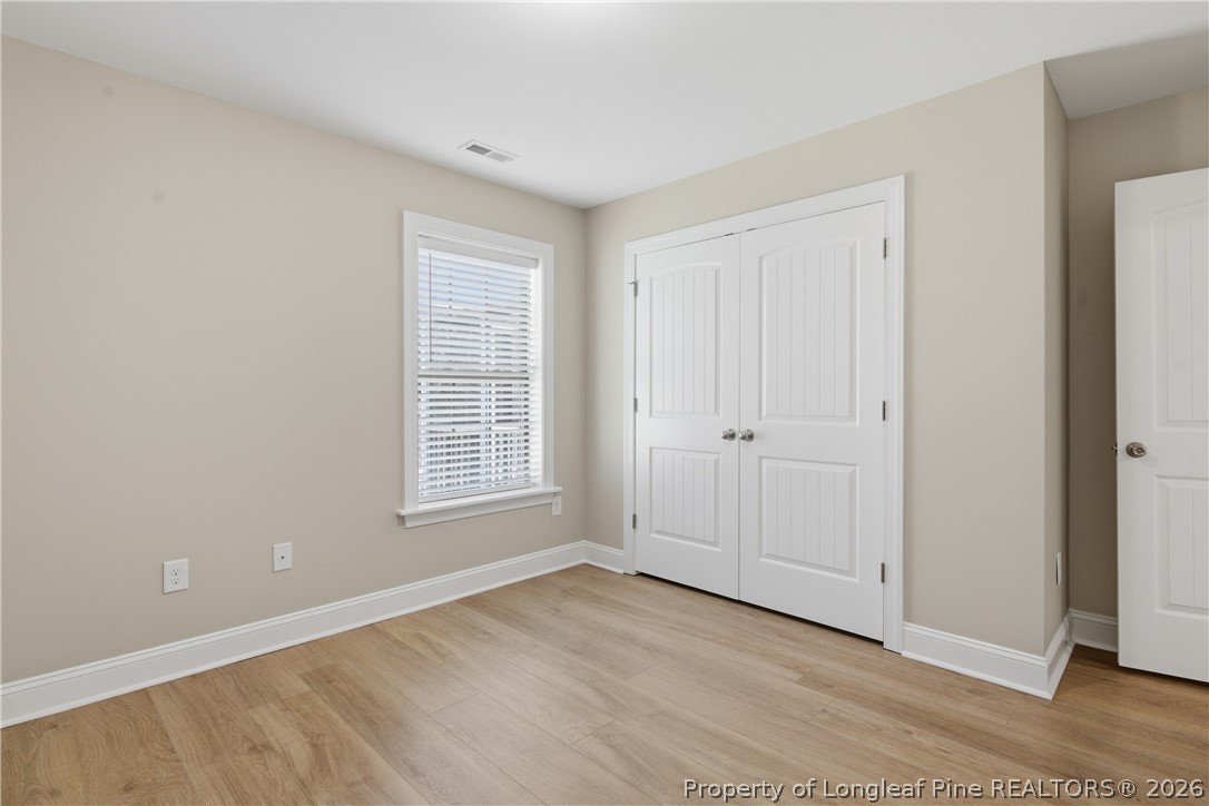 415 Colonist Place Cameron, NC 28326 - Photo 36 of 49 a view of an empty room with wooden floor and a window