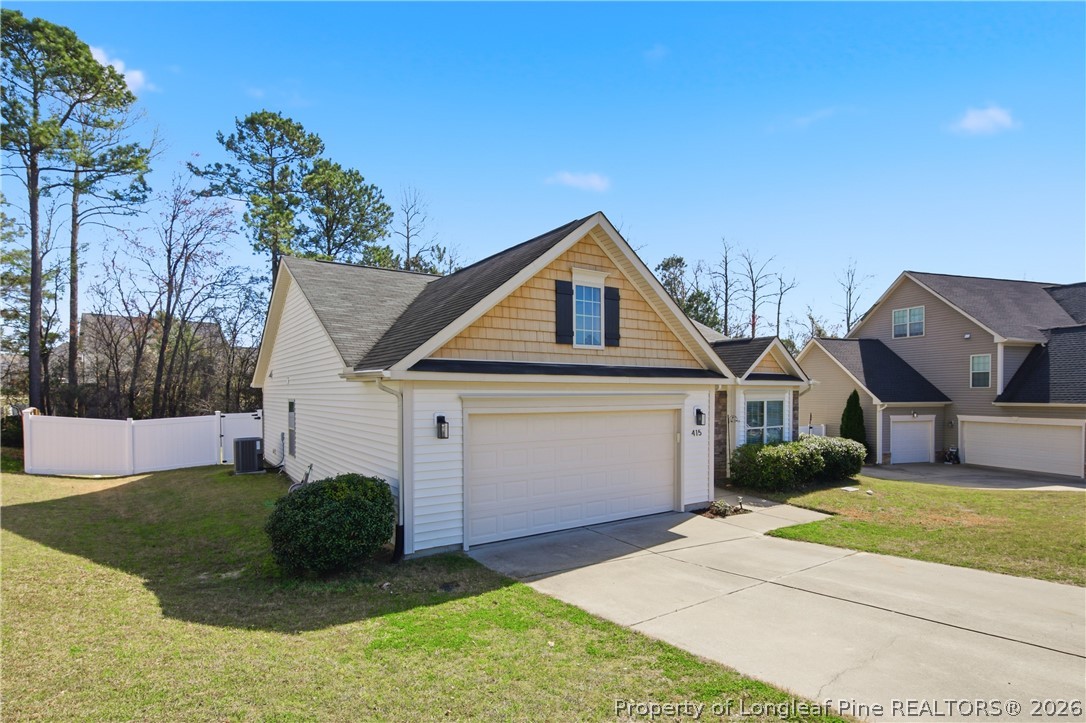 415 Colonist Place Cameron, NC 28326 - Photo 44 of 49 a front view of a house with a yard and garage