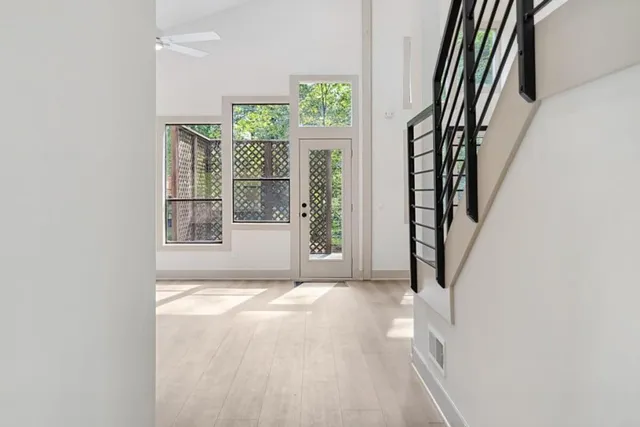 an empty room with windows and fireplace