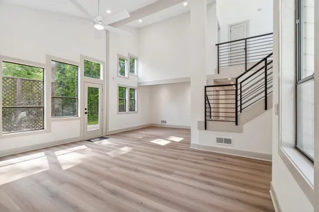 a view of empty room with stairs and fireplace