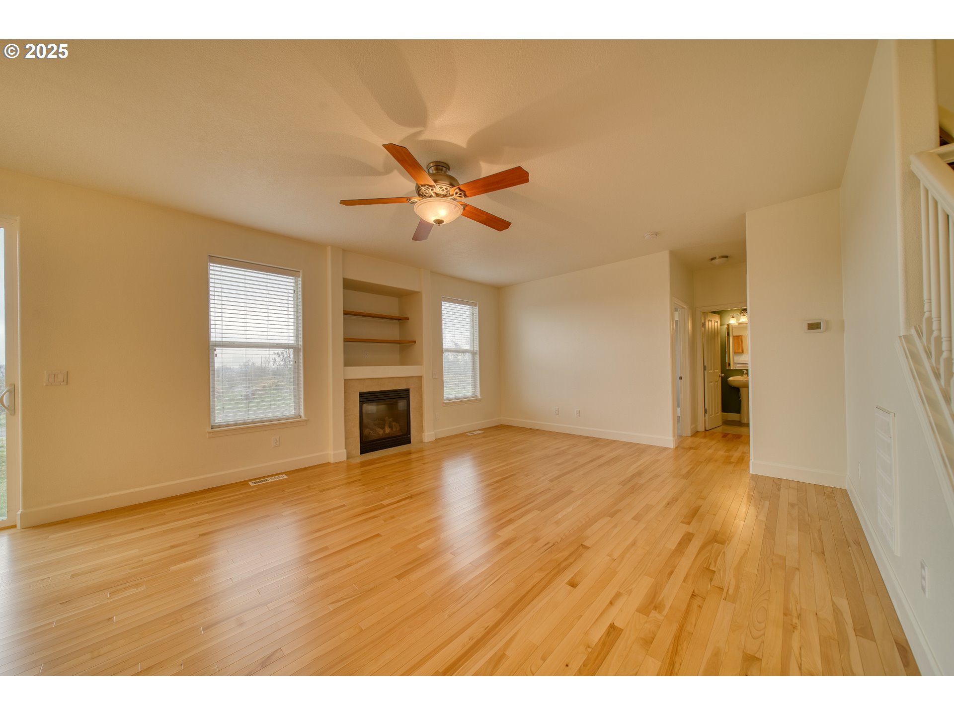 52036 Southeast Icenogle Loop Scappoose, OR 97056 - Photo 14 of 41 a view of empty room with wooden floor and fan