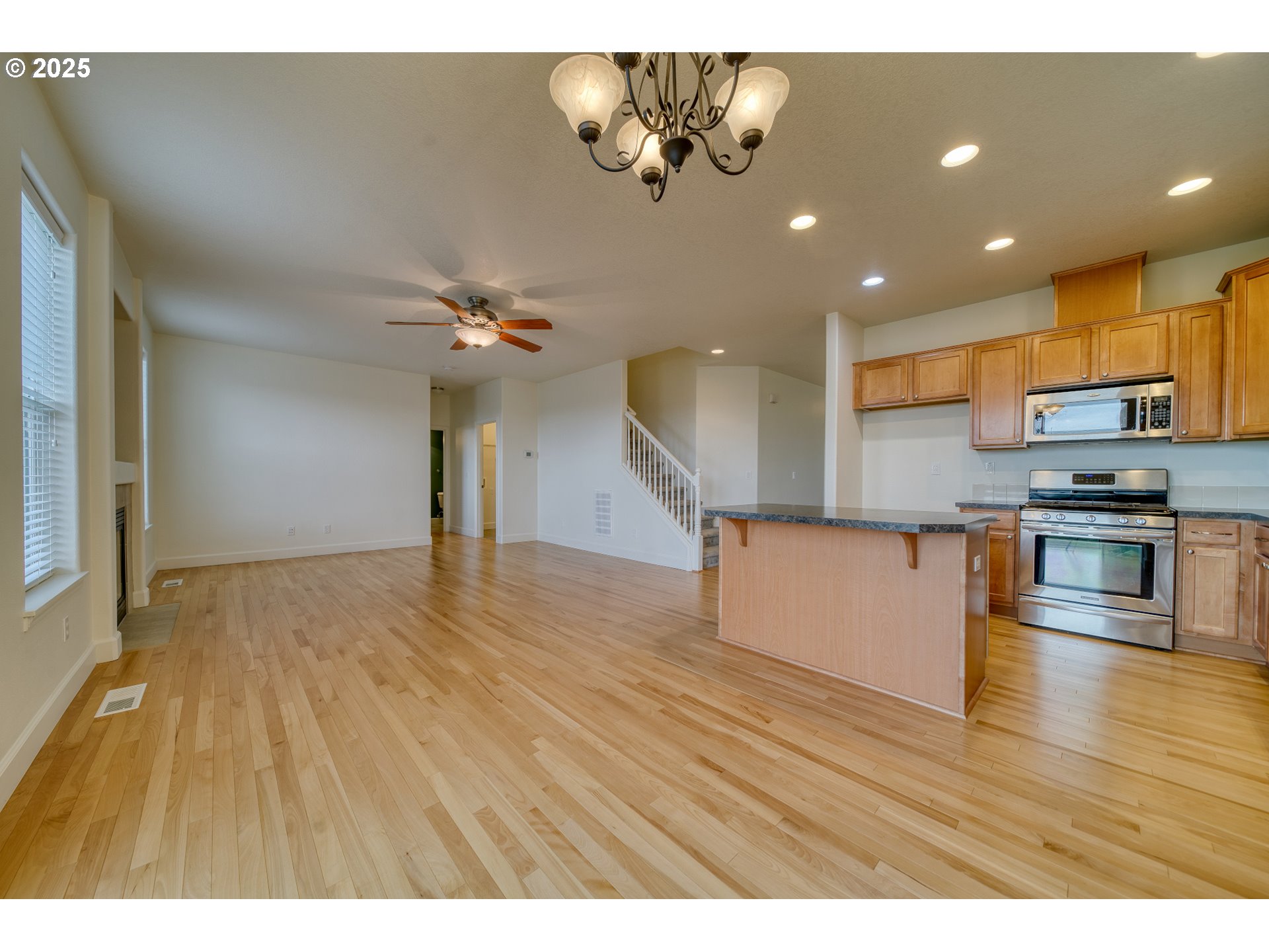 52036 Southeast Icenogle Loop Scappoose, OR 97056 - Photo 18 of 41 a view of kitchen with stainless steel appliances granite countertop a stove top oven a sink with wooden floors