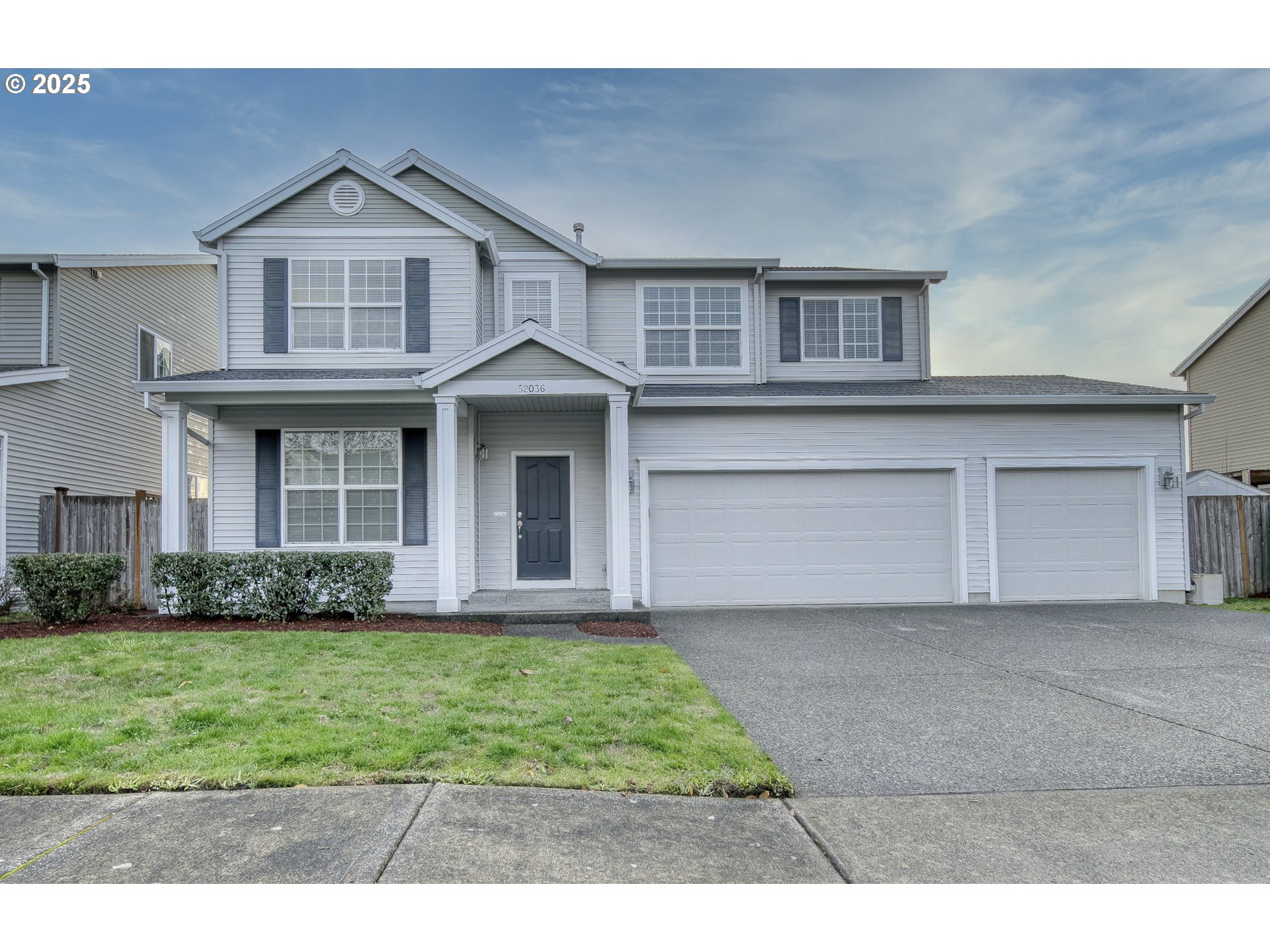 52036 Southeast Icenogle Loop Scappoose, OR 97056 - Photo 2 of 41 a front view of a house with a yard and garage