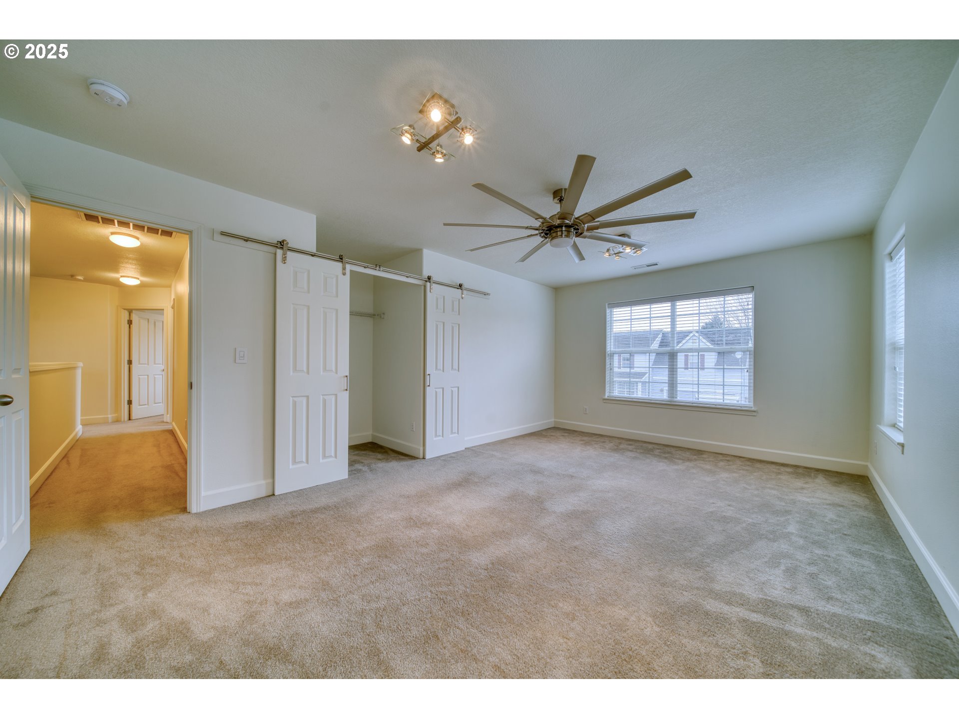 52036 Southeast Icenogle Loop Scappoose, OR 97056 - Photo 23 of 41 a view of a livingroom with a ceiling fan and window