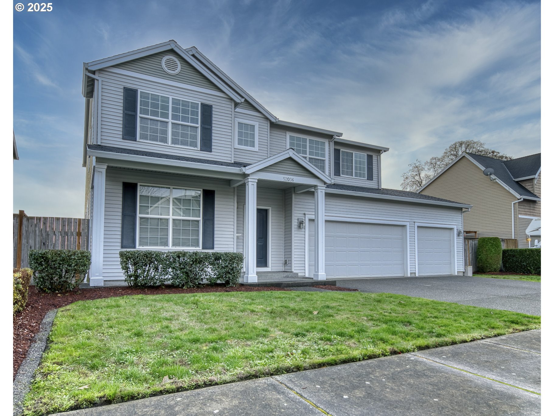 52036 Southeast Icenogle Loop Scappoose, OR 97056 - Photo 5 of 41 a front view of a house with a garden