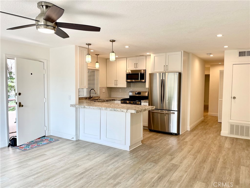 352 Y Place, Unit B Laguna Beach, CA 92651 - Photo 2 of 20 a kitchen with stainless steel appliances a refrigerator and a stove top oven