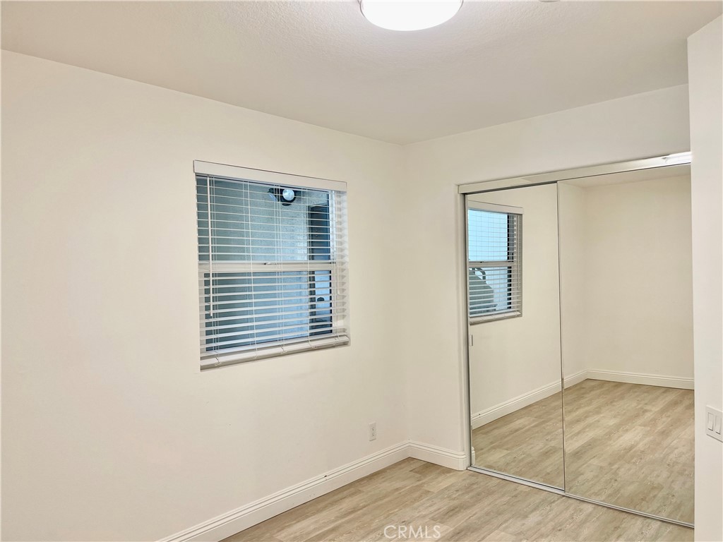 352 Y Place, Unit B Laguna Beach, CA 92651 - Photo 9 of 20 a view of an empty room with wooden floor and a window