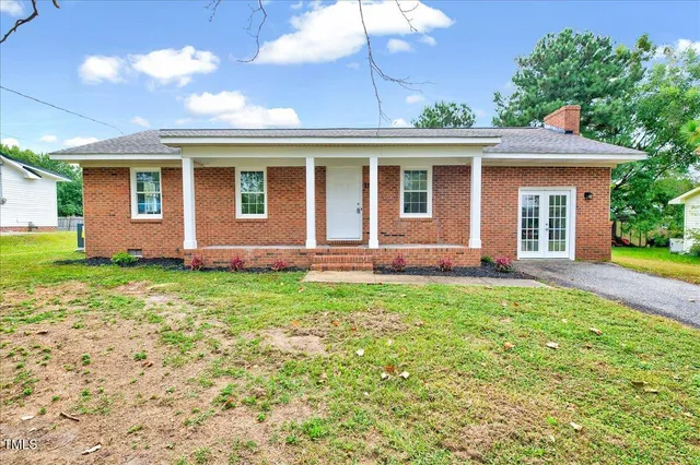 a front view of house with yard and green space