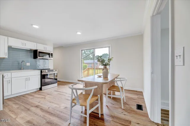 a workspace with wooden floor and a window