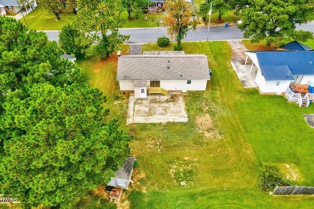 an aerial view of a house with a yard basket ball court and outdoor seating