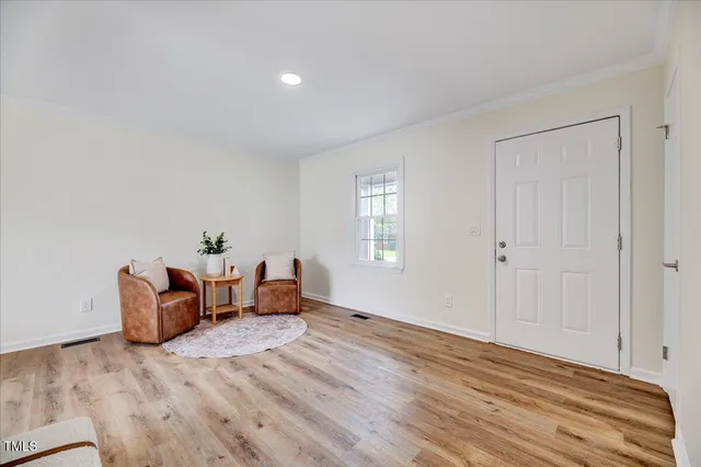 a bedroom with furniture and wooden floor