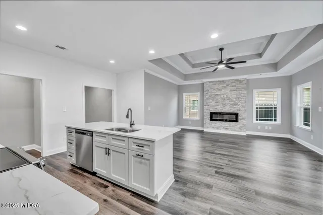 a view of kitchen with sink microwave and stove