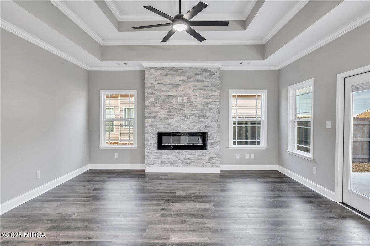 100 Early Drive Byron, GA 31008 - Photo 15 of 49 an empty room with wooden floor a fireplace a ceiling fan and windows