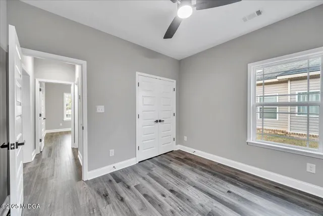 a view of a room with wooden floor and a window