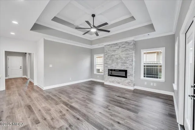 a view of an empty room with a fireplace and a window