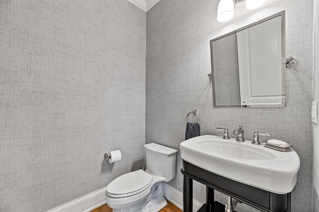 a bathroom with a sink a toilet and mirror