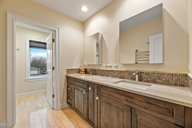 a bathroom with a double vanity sink and a mirror