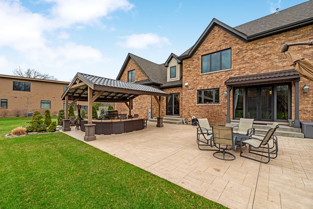 a view of a house with backyard and porch