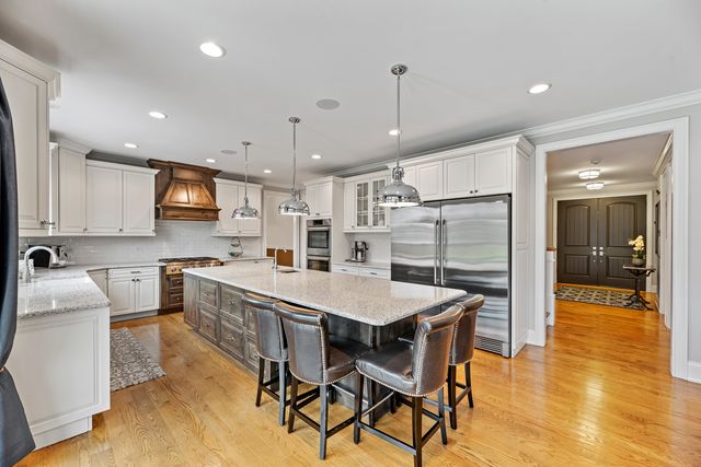 a large kitchen with a table and chairs in it