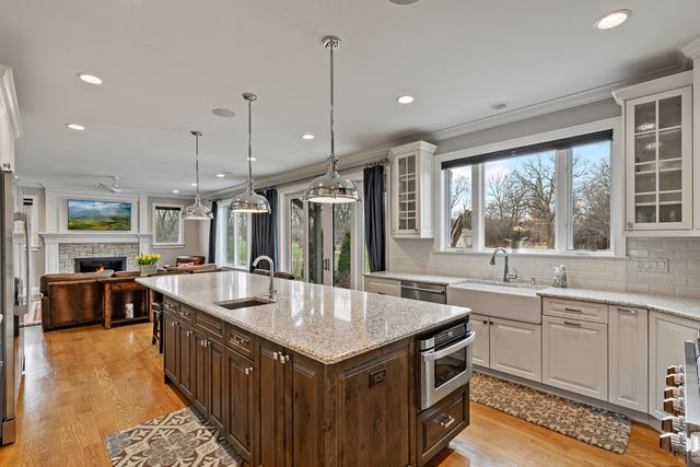 a kitchen with stainless steel appliances granite countertop a sink and a stove