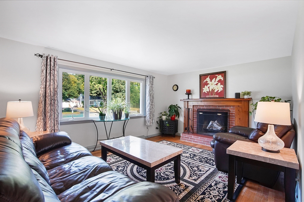 407 Wolf Swamp Road Longmeadow, MA 01106 - Photo 12 of 42 a living room with furniture a fireplace and a large window