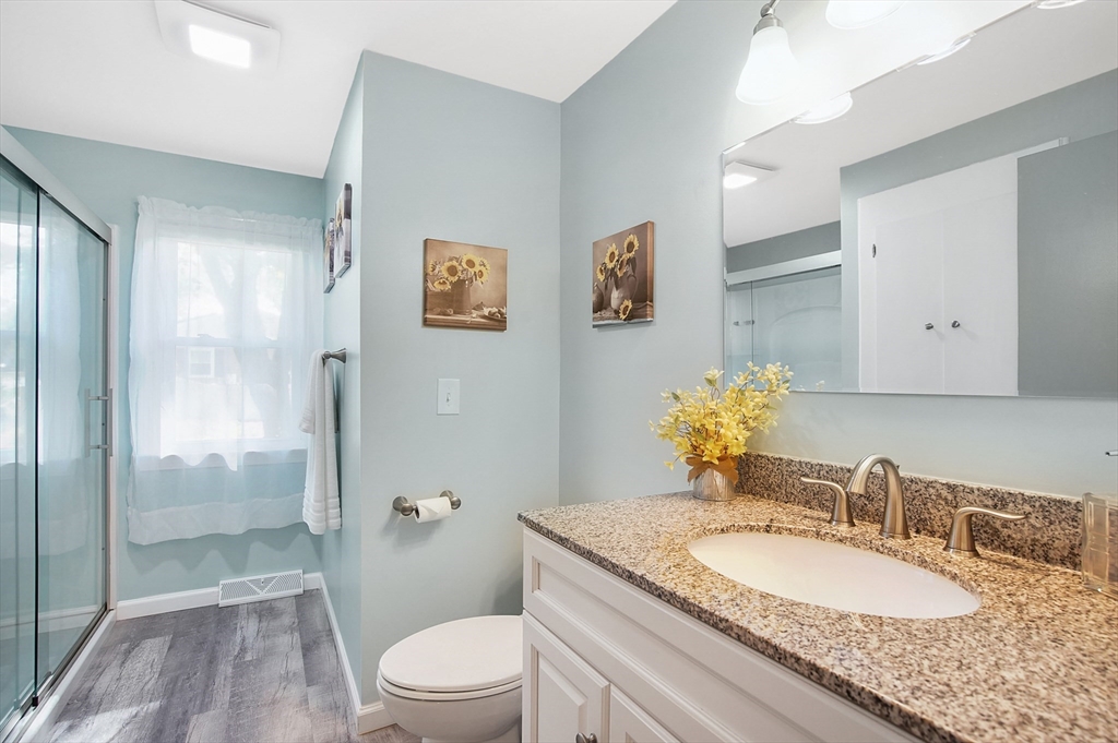 407 Wolf Swamp Road Longmeadow, MA 01106 - Photo 16 of 42 a bathroom with a granite countertop sink a mirror and a toilet