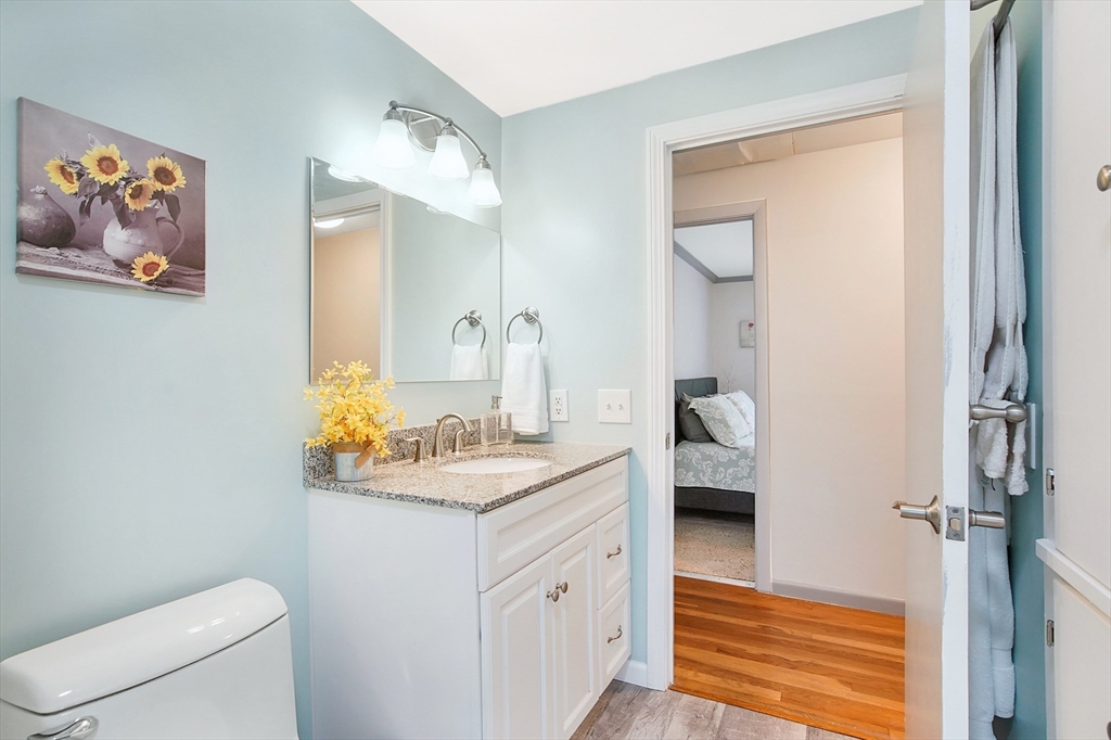 407 Wolf Swamp Road Longmeadow, MA 01106 - Photo 18 of 42 a spacious bathroom with a granite countertop sink and a mirror